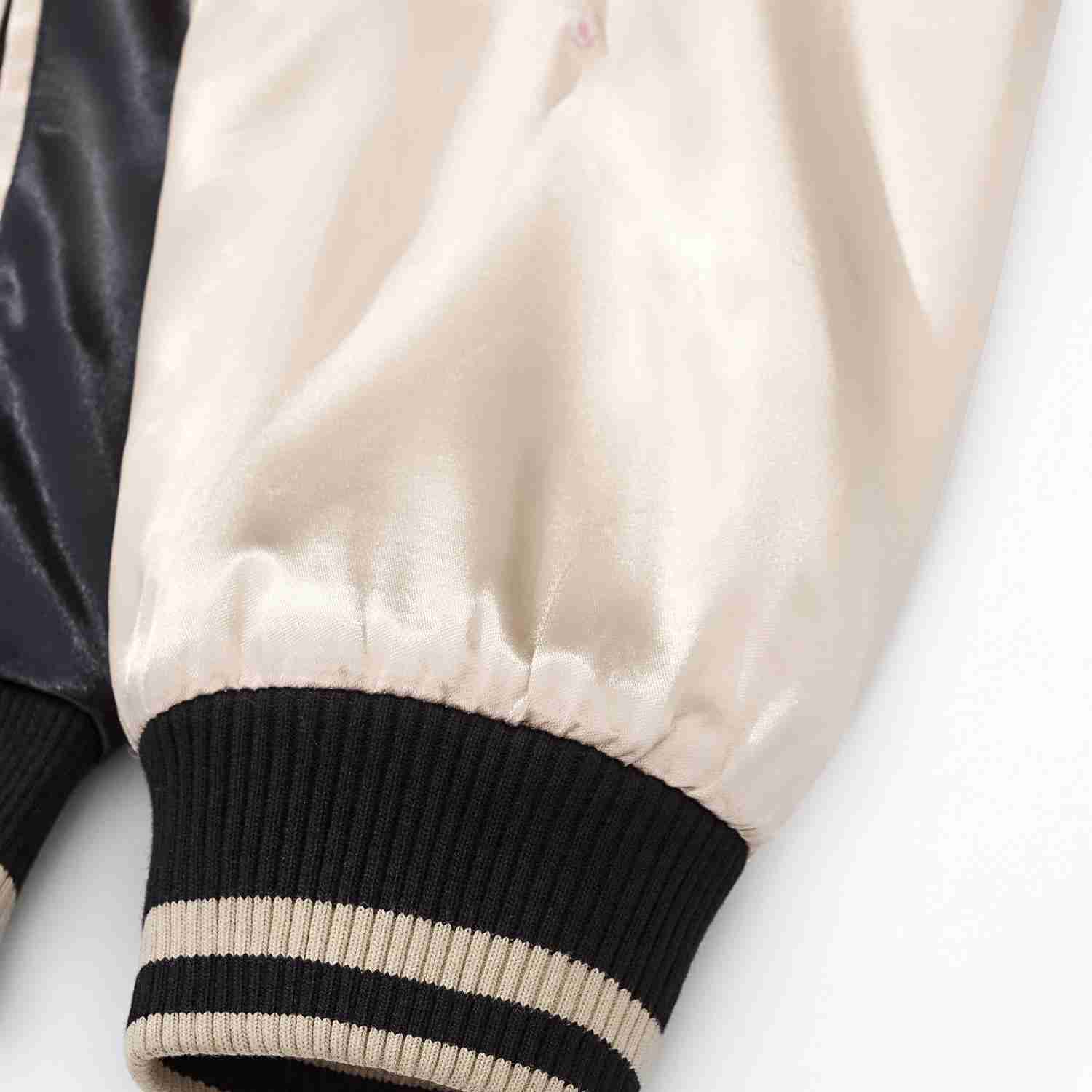 Ribbed cuff and glossy beige sleeve fabric.