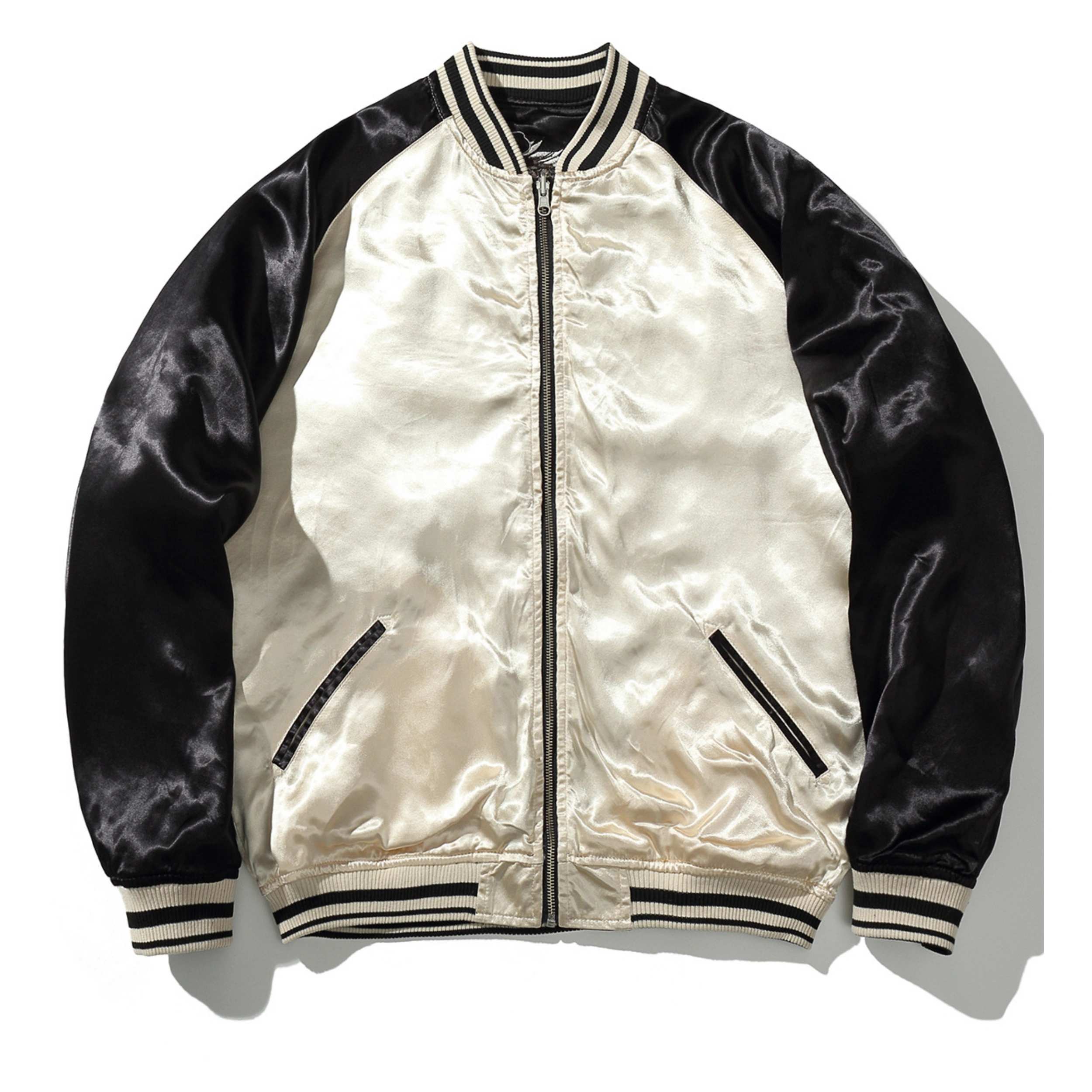 ivory side front view with minimalist panel and wave-cloud stitching on shoulders; reversible.