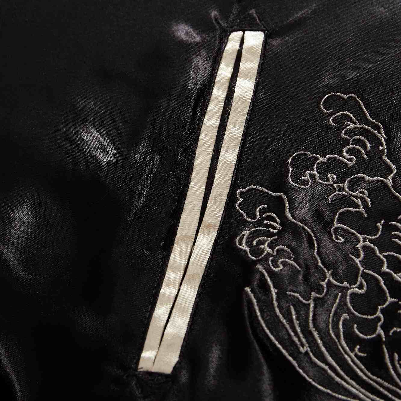 Pocket detail — black side slanted welt with ivory piping.