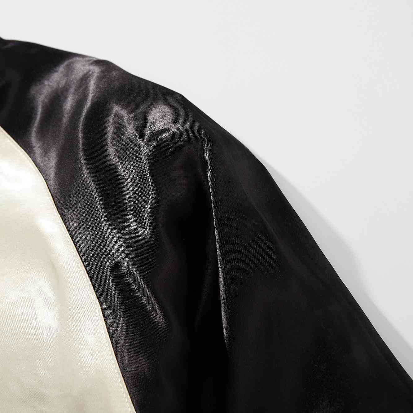 Sleeve detail — black side satin sheen.