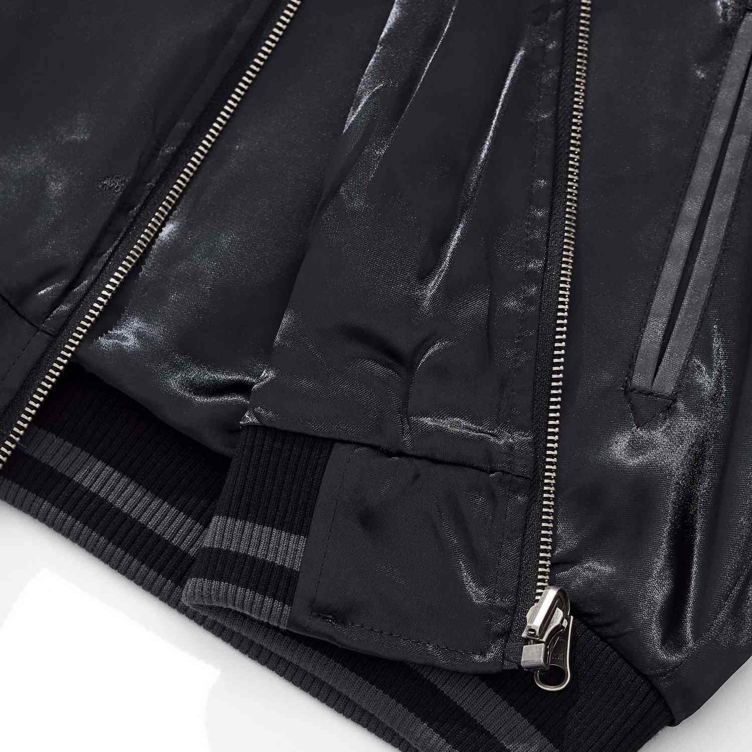 Hem rib and front zipper with pocket opening detail.