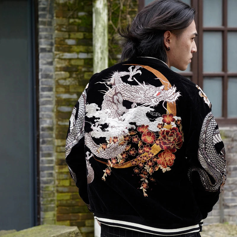 Lifestyle — model wearing velvet sukajan (Black), back view; white dragon coiling through clouds with crescent moon and plum blossoms.