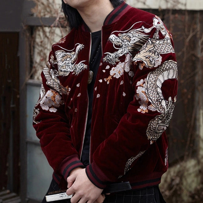 Lifestyle — model wearing velvet sukajan (red), front view; embroidered dragons on shoulders with scattered petals.