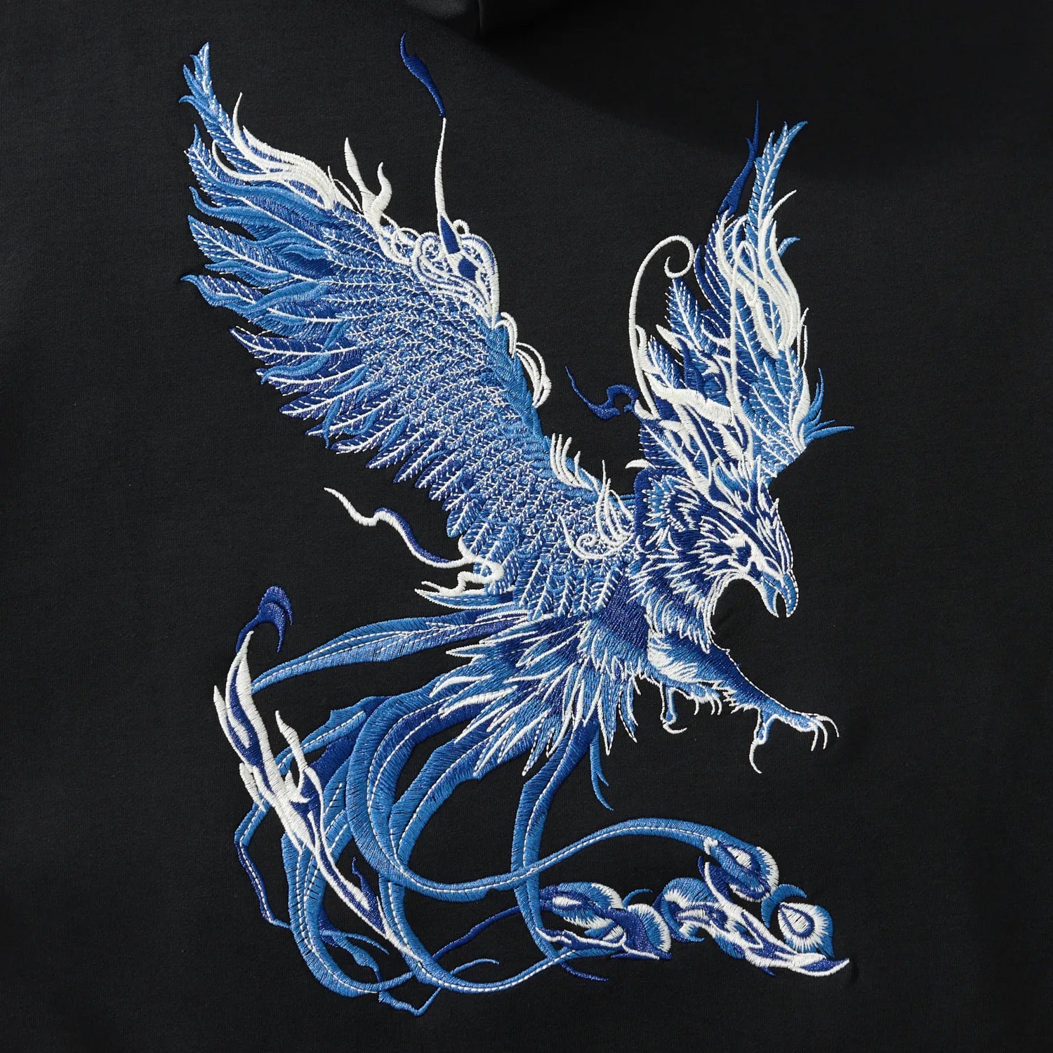 Back embroidery close-up of the blue phoenix on the black hoodie with layered threads
