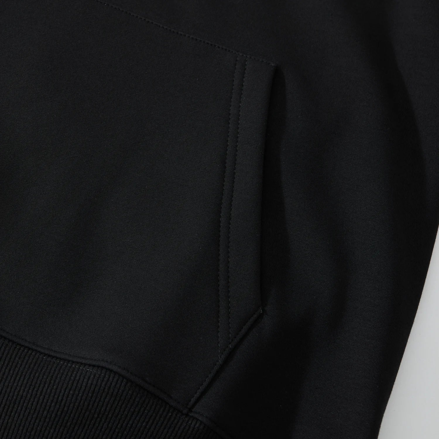 Kangaroo pocket detail on the black Blue Phoenix & Lotus Embroidered Hoodie with tidy topstitching
