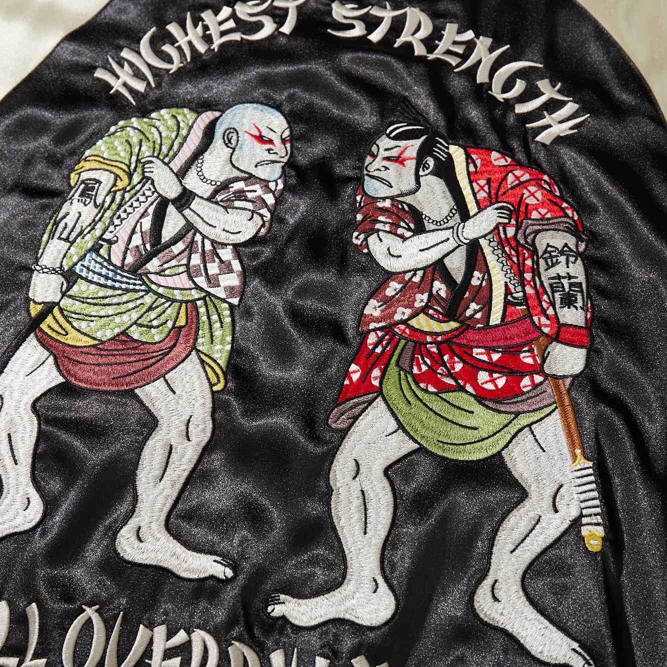 Close-up of two brawler characters facing off on back embroidery of Crows Suzuran vs Housen Japanese sukajan jacket.