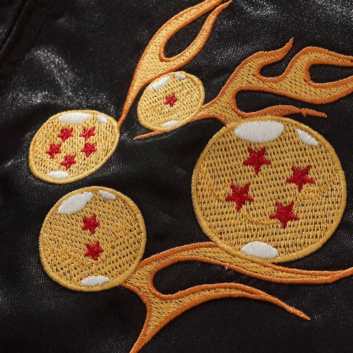 Macro embroidery detail of flaming Dragon Balls motif on the chest of Dragon Ball sukajan jacket.