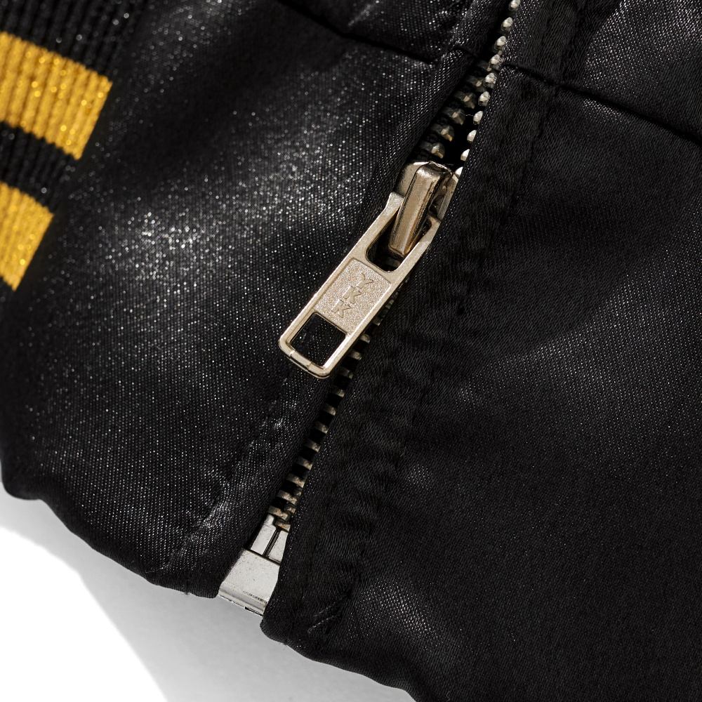 Close-up of sturdy metal zipper on black satin Dragon Balls Goku Kamehameha sukajan jacket.