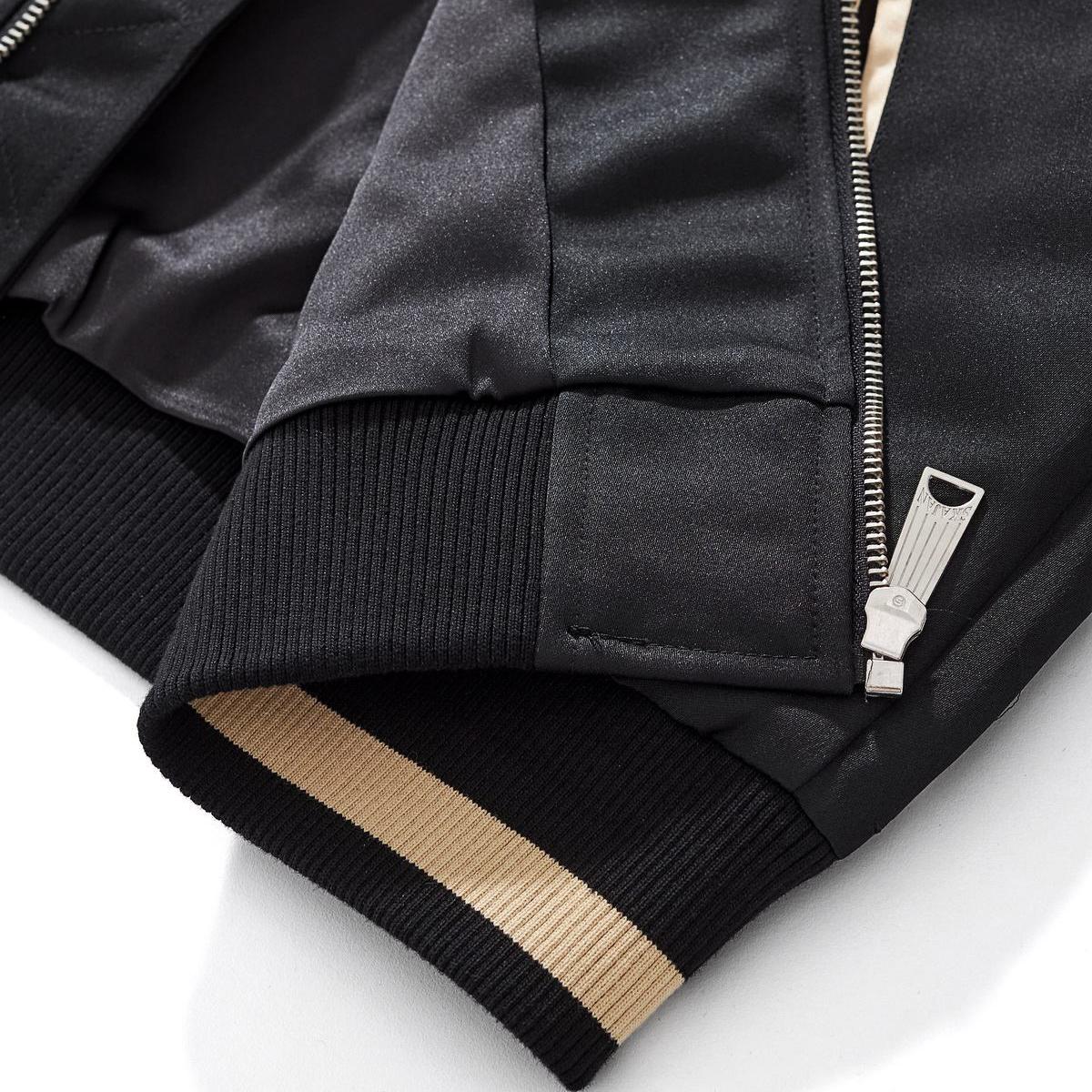 Reinforced hem with a metal zipper and inner wind flap; durable rib knit for comfort.