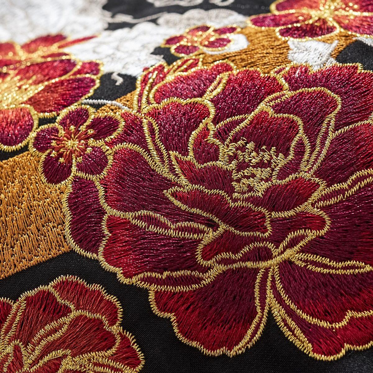 Peony and blossom embroidery with gold outlines—vivid color and high thread density.