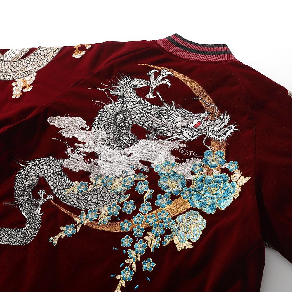 Close-up of back embroidery with dragon, cloud plumes, and sakura blossoms arranged around a circular halo