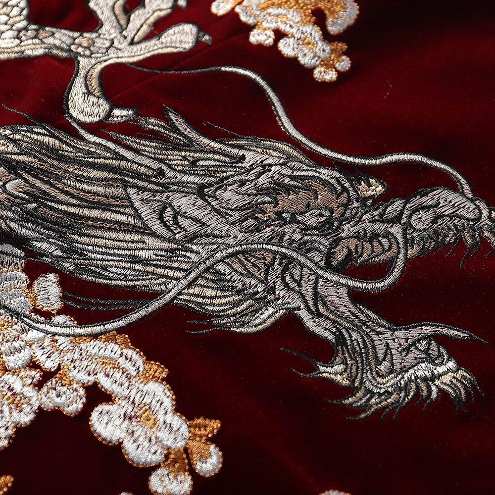 Close-up of dragon head embroidery with layered satin stitches