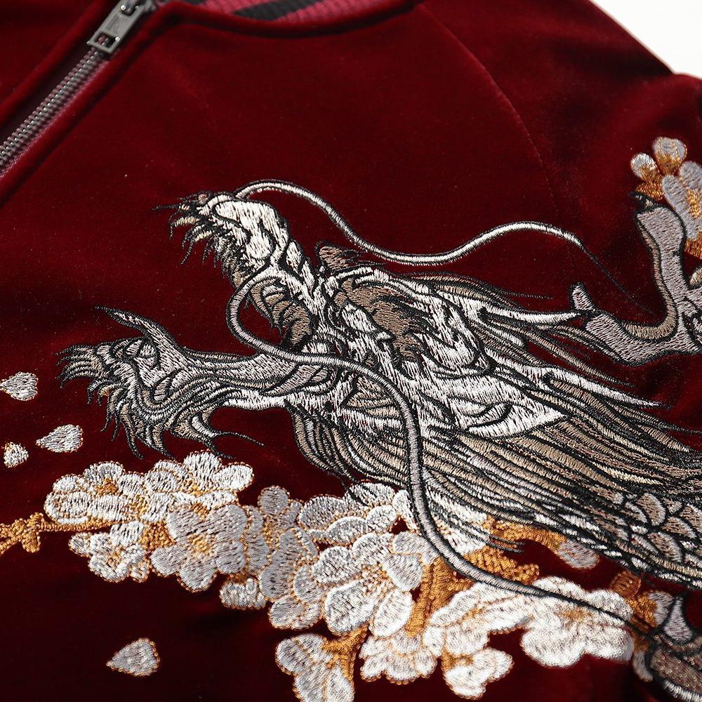 Chest embroidery detail featuring a dragon head over flowing cloud plumes