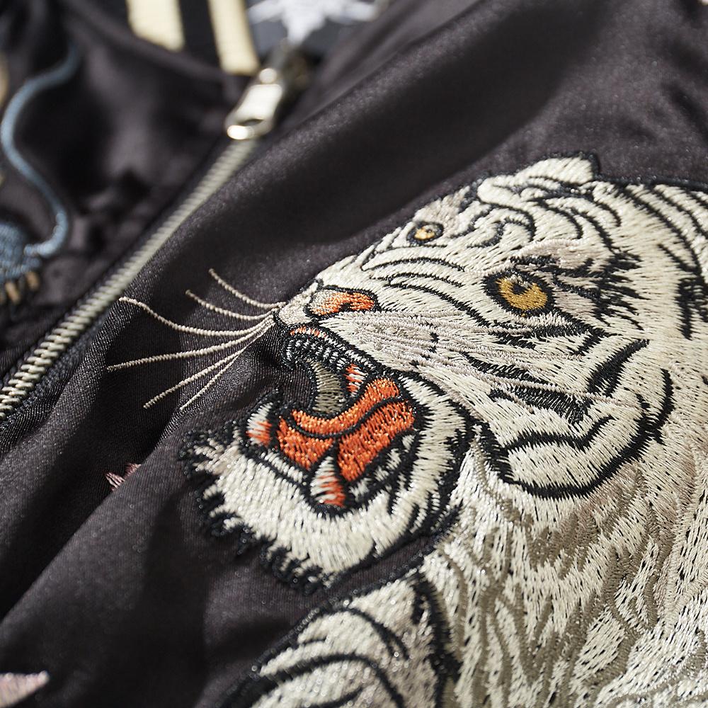 Close-up of roaring white tiger face embroidery on the left chest