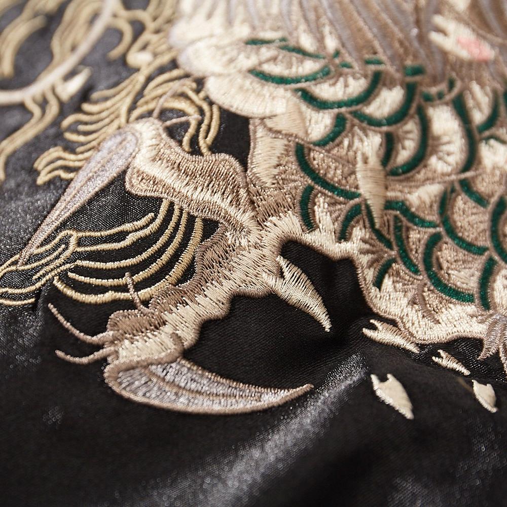 Close-up of dragon claw and scales embroidery on a black sukajan