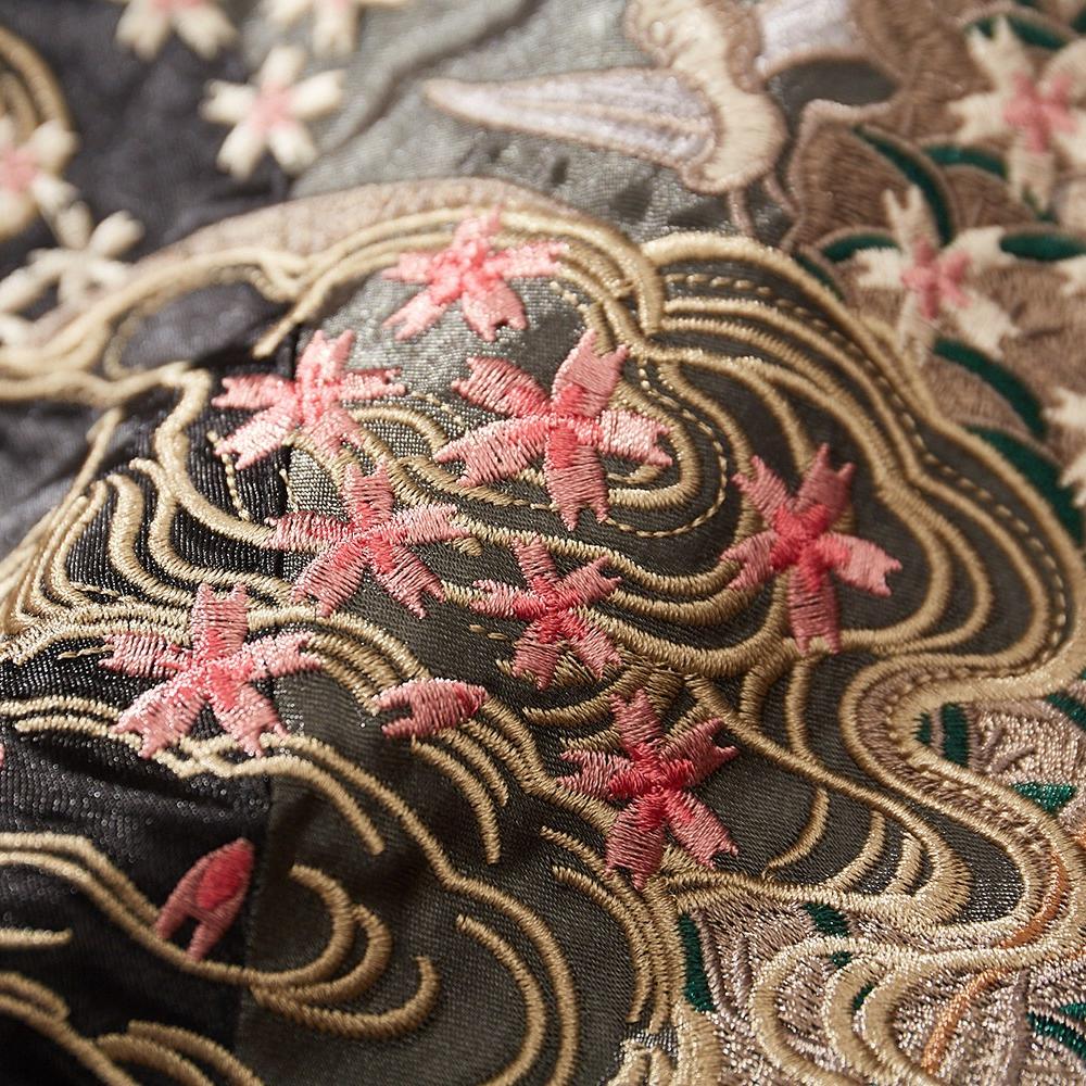 Close-up of sakura blossoms and wave embroidery on a black sukajan