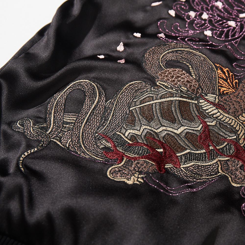 Close-up of tortoise and snake embroidery on the back of a black sukajan