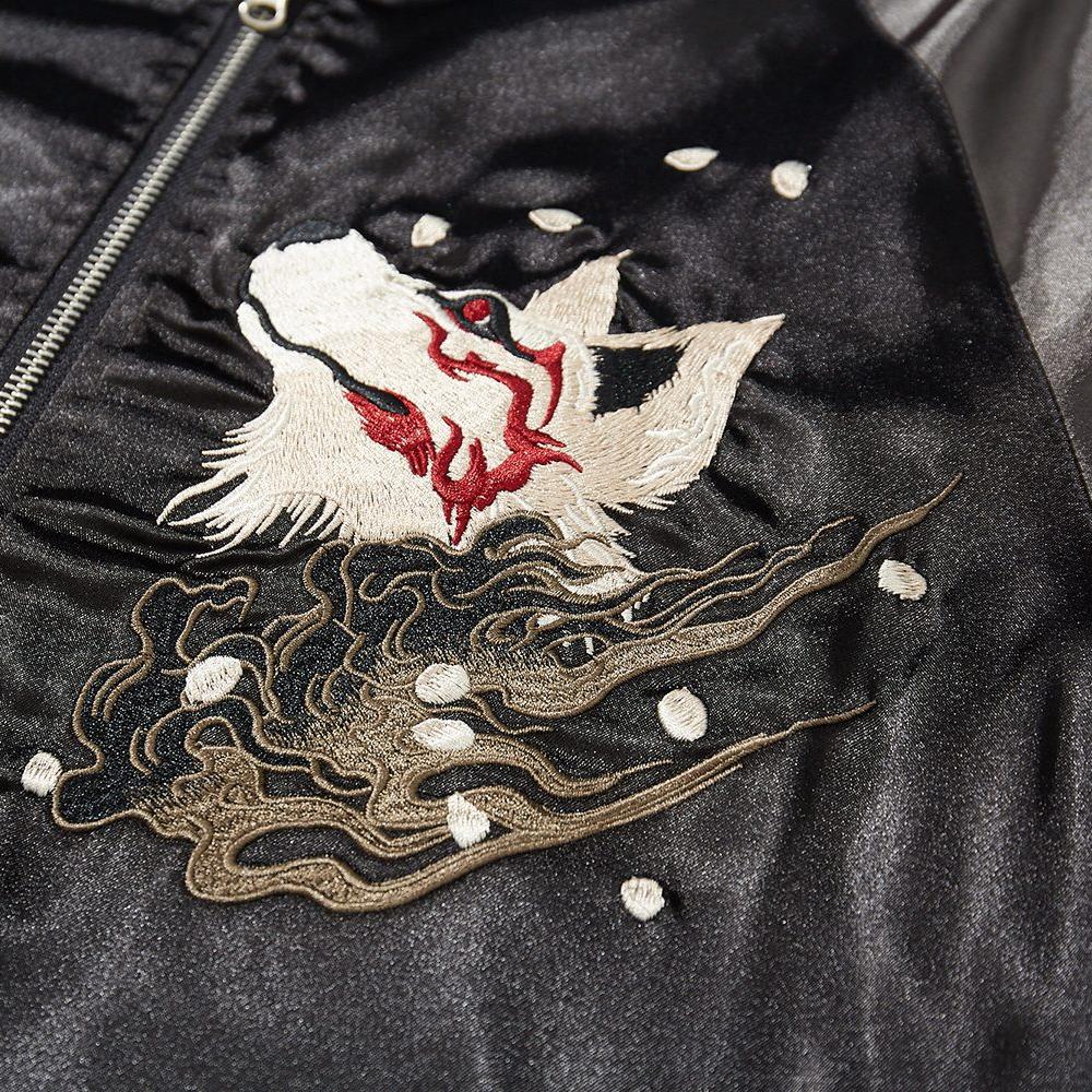 Close-up of fox head embroidery with swirling mist and petals on the front
