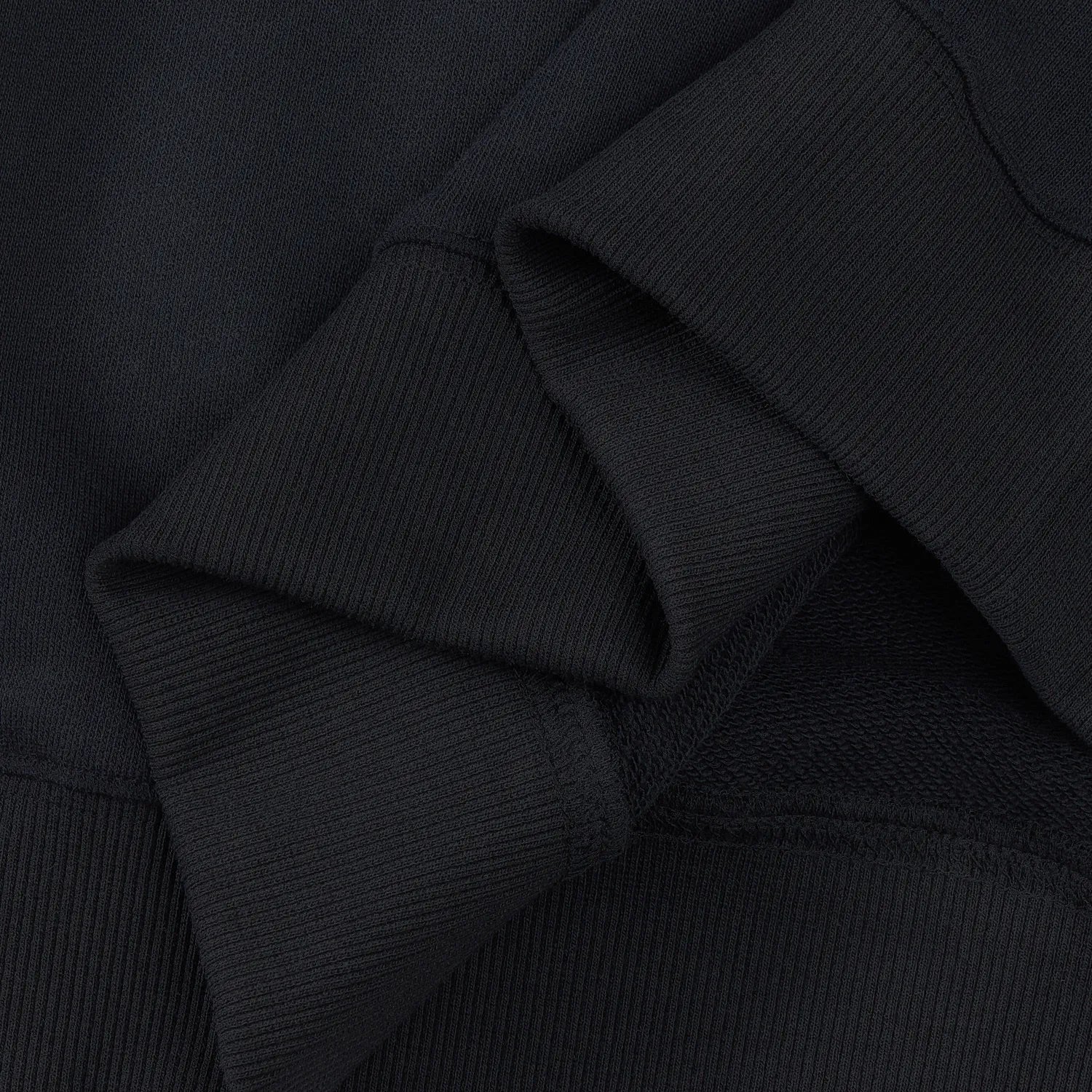 Inside view of ribbed cuff and stitching on black Nine-Tailed Fox & Lotus sweatshirt