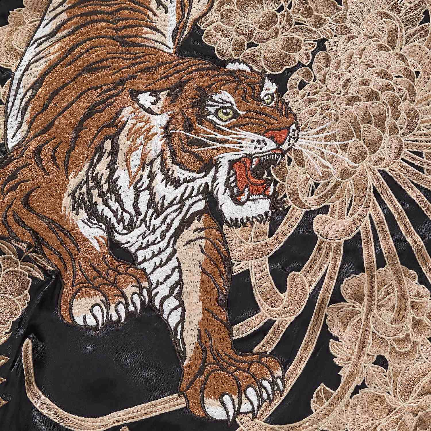 Close-up of roaring tiger with chrysanthemum petals on the sukajan jacket