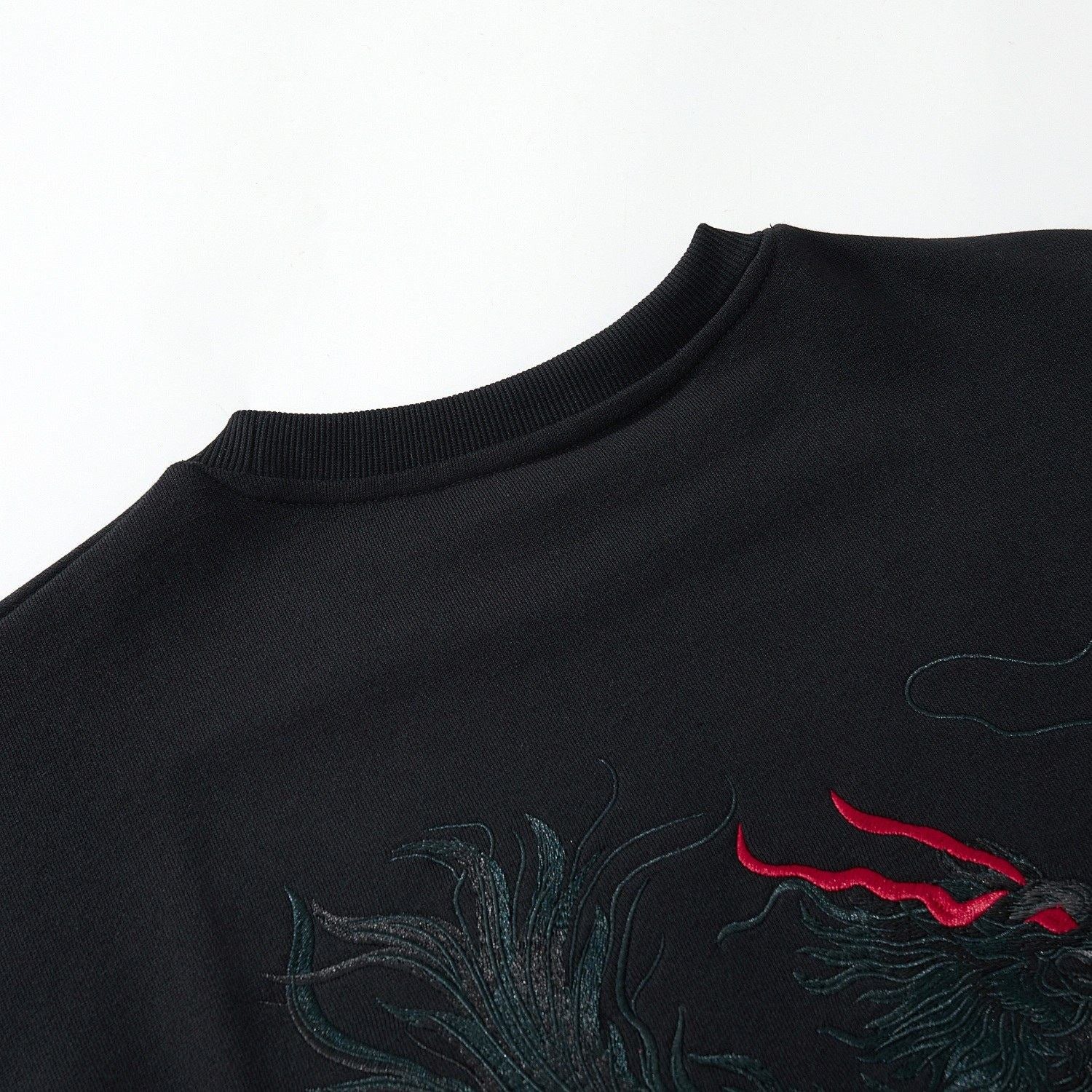 Back collar close-up of the black Kirin & Lotus Embroidered Sweatshirt with Kirin stitching and ribbed neckline