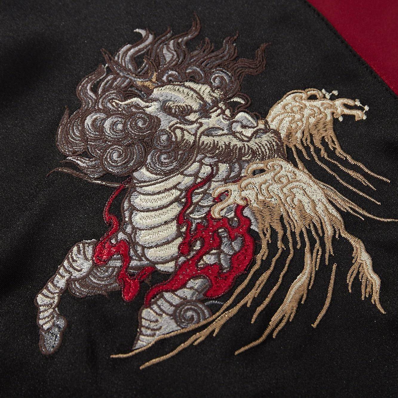Close-up of kirin head embroidery with layered satin stitches and flowing whiskers