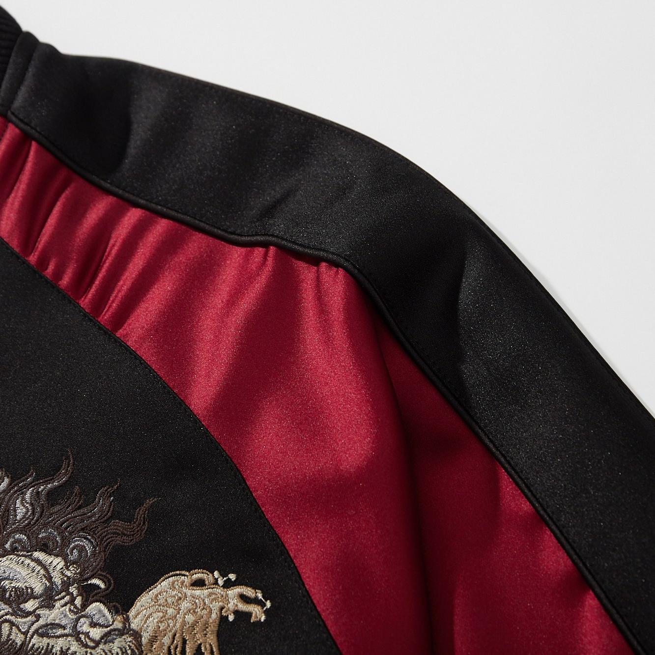 Sleeve panel detail showing the contrast satin stripe