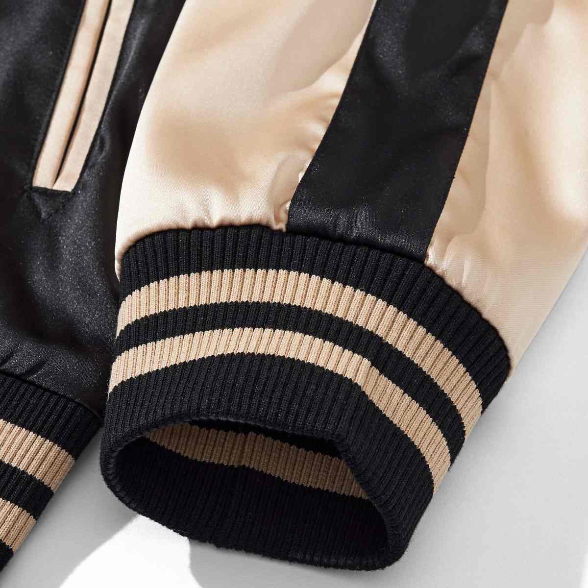Beige color sukajan jacket ribbed cuff detail with twin contrast stripes.