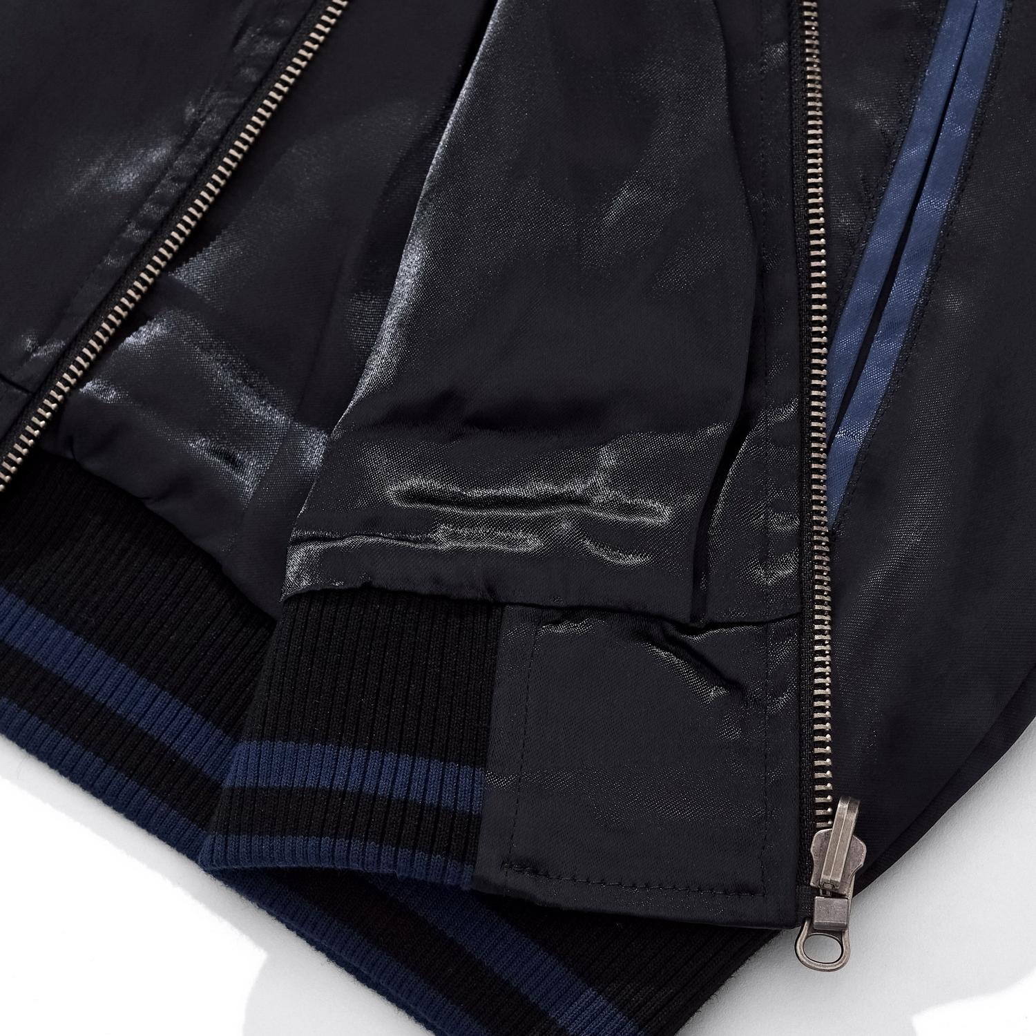 Close-up of the ribbed hem and zipper base showing the premium blue rayon fabric texture.