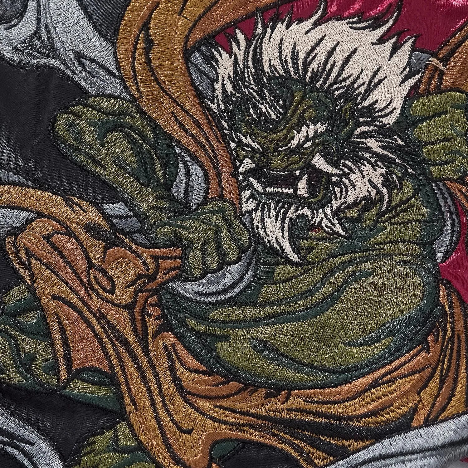 Macro shot showing the high-density thread texture of the Japanese mythology embroidery.