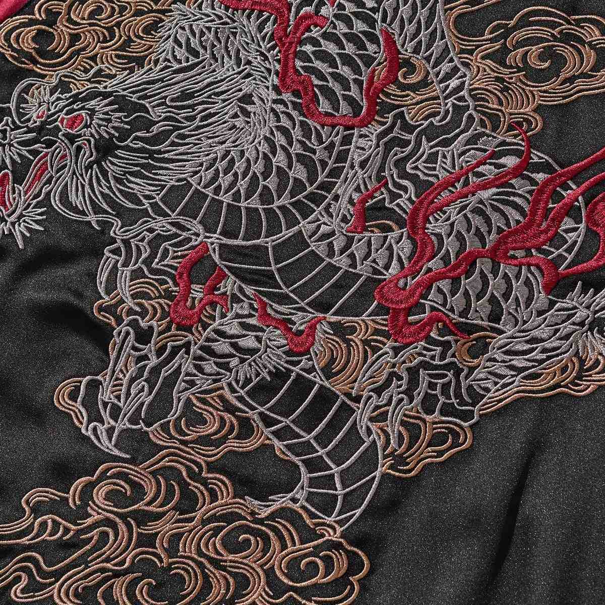 Back embroidery detail—line-art dragon with flame accents and rolling clouds.