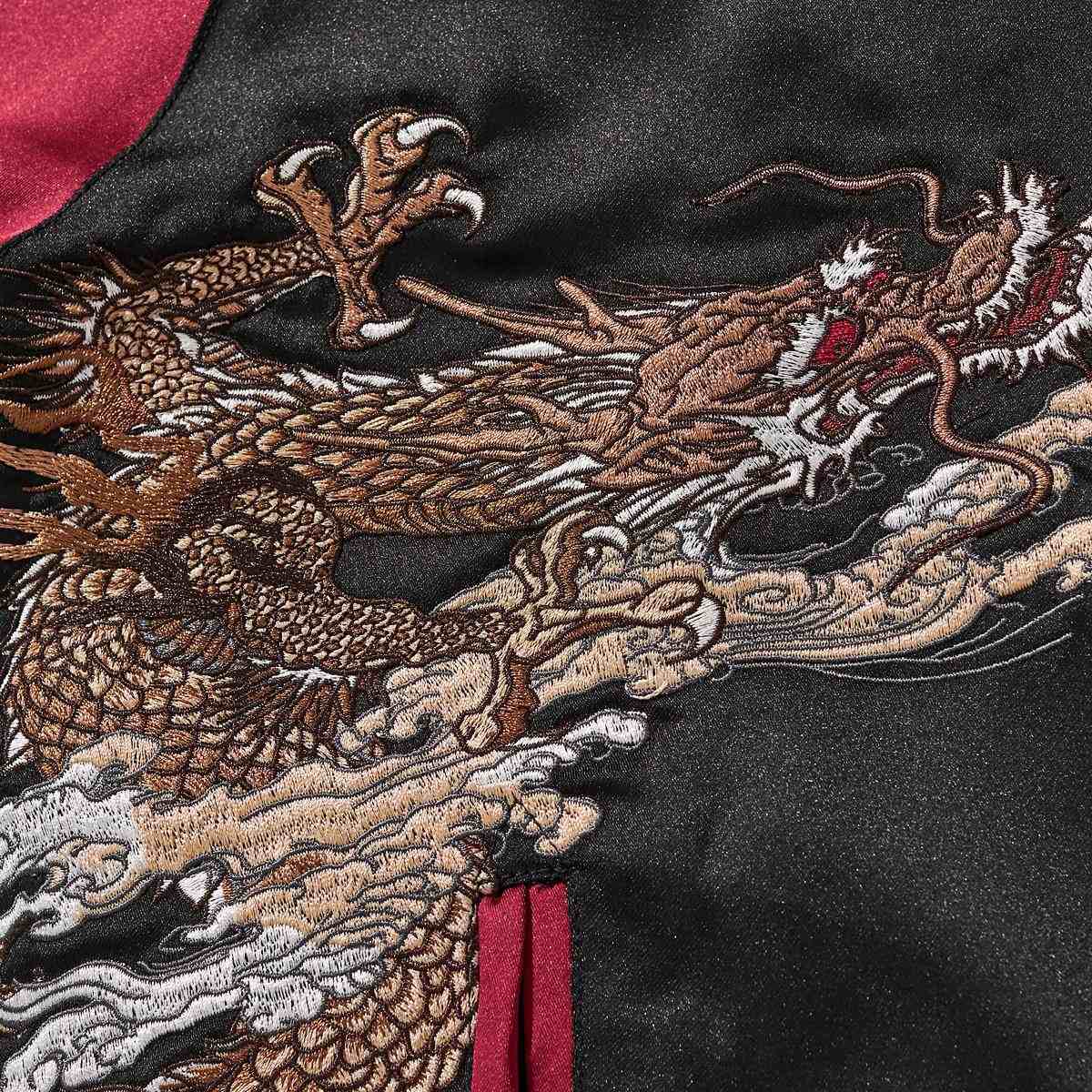 Close-up of dragon head and claw with billowing clouds—dense satin stitching.
