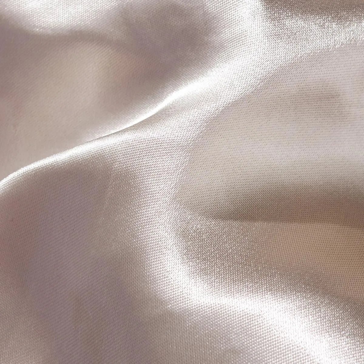 Macro photography showing the fine weave and soft sheen of the satin fabric on the reverse side.