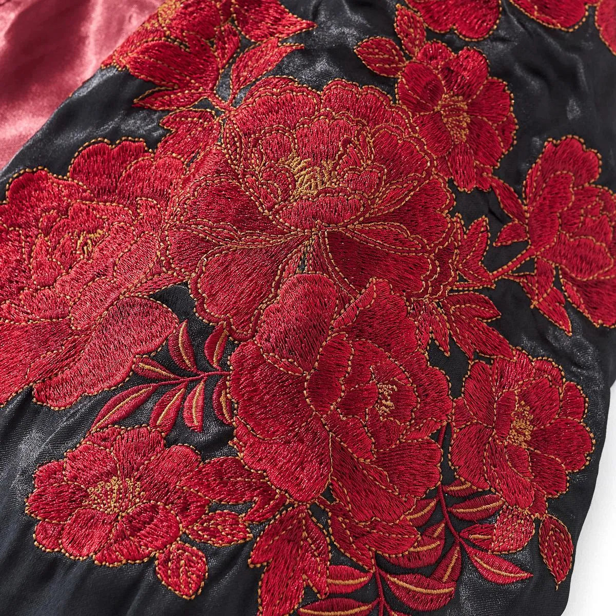 Close-up of the detailed floral embroidery featuring blooming peonies.