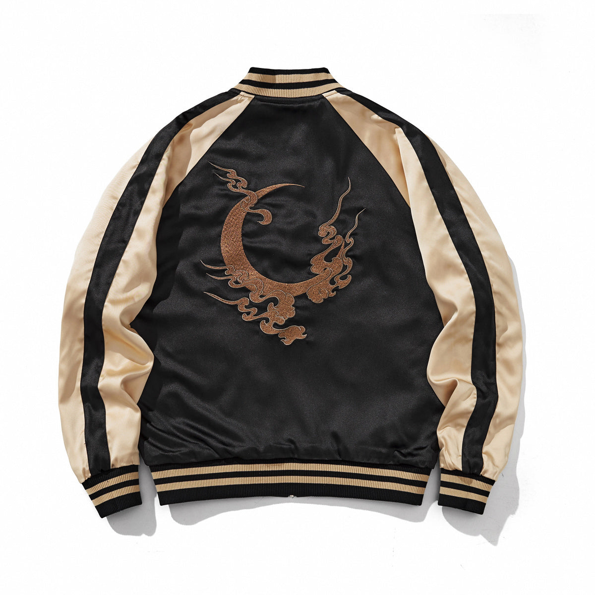 Bronze crescent-and-cloud emblem centered on a reversible sukajan jacket, back view, side B, beige.