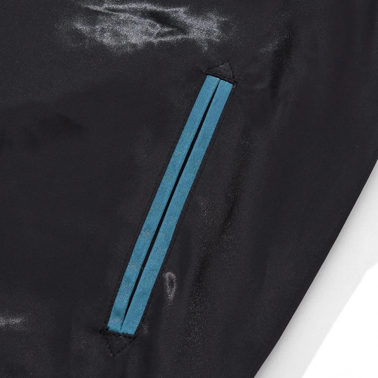 Detail of the reinforced side pocket with blue trim on the black/blue satin body.