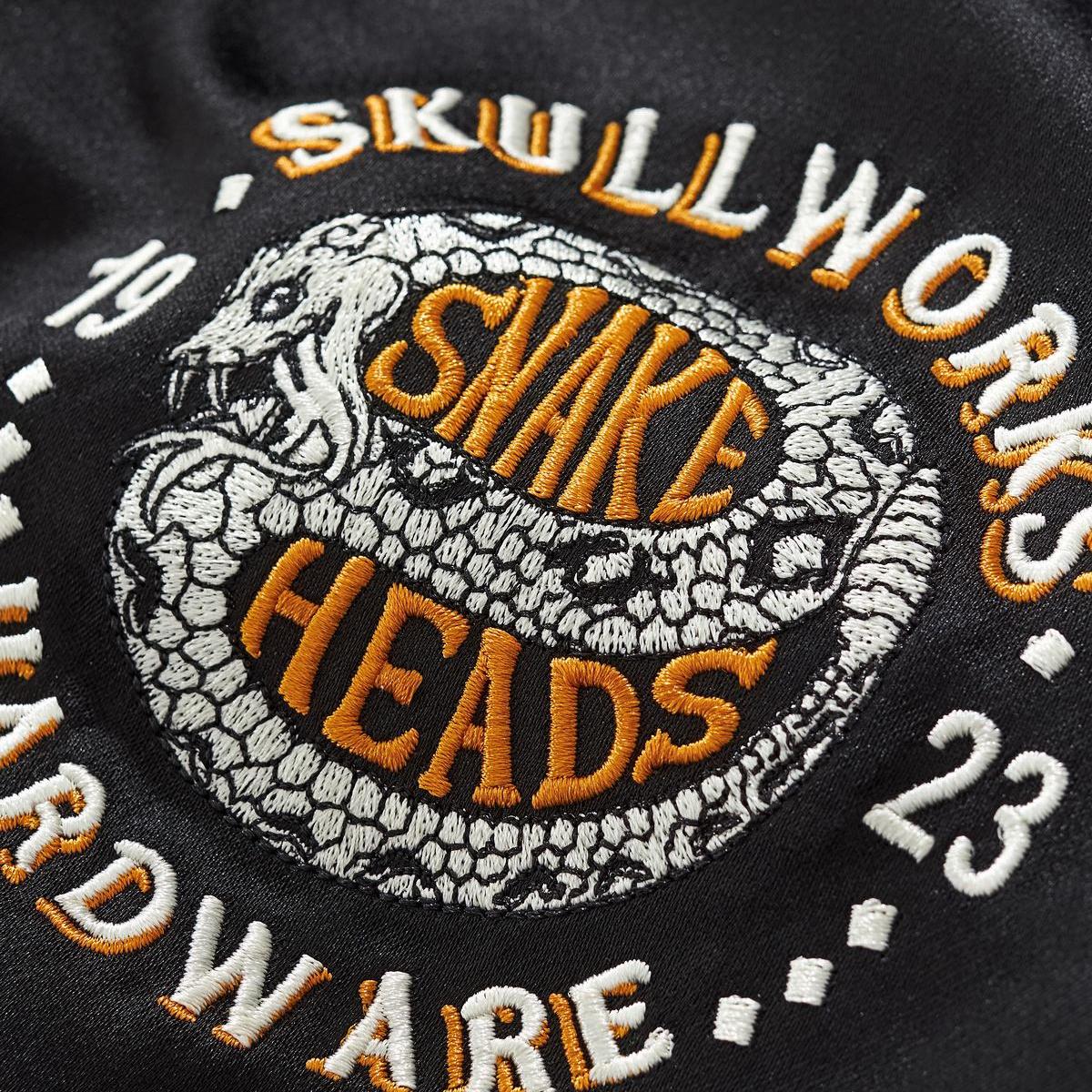Close up of chest crest embroidery with coiled snake motif