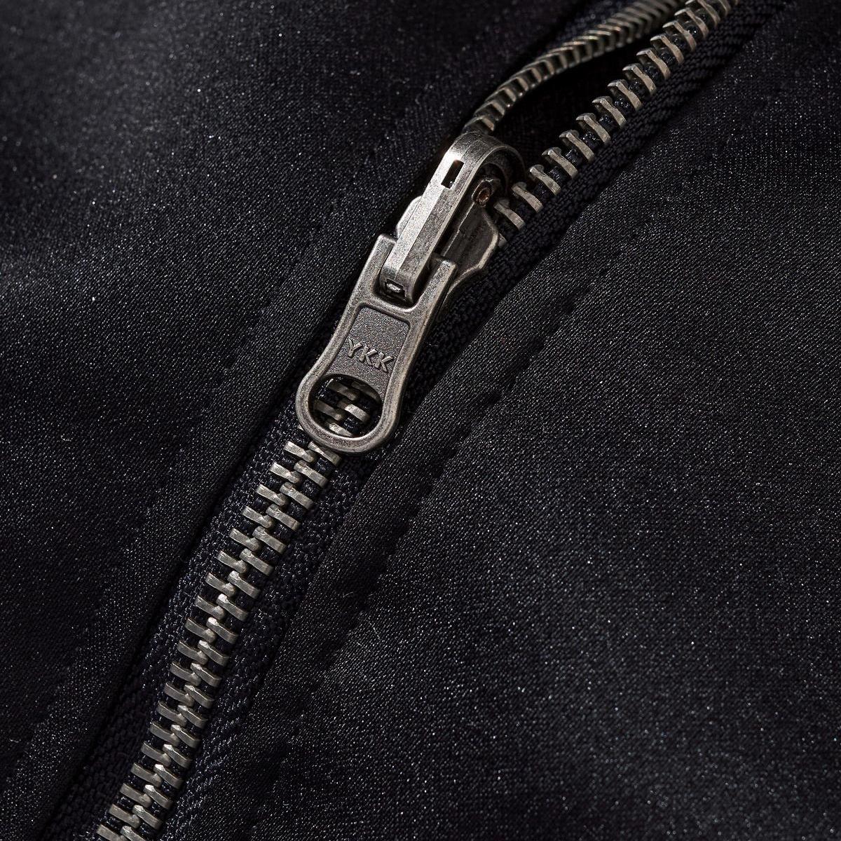 Metal YKK zipper close-up with fine teeth