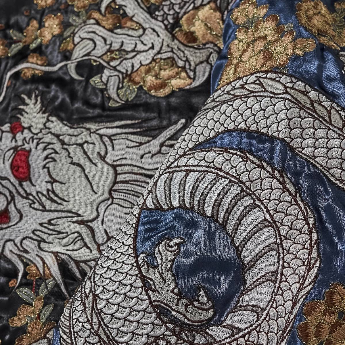 Macro detail of silver dragon and peony storm embroidery wrapping the sleeve on Storm Dragons & Peony sukajan.