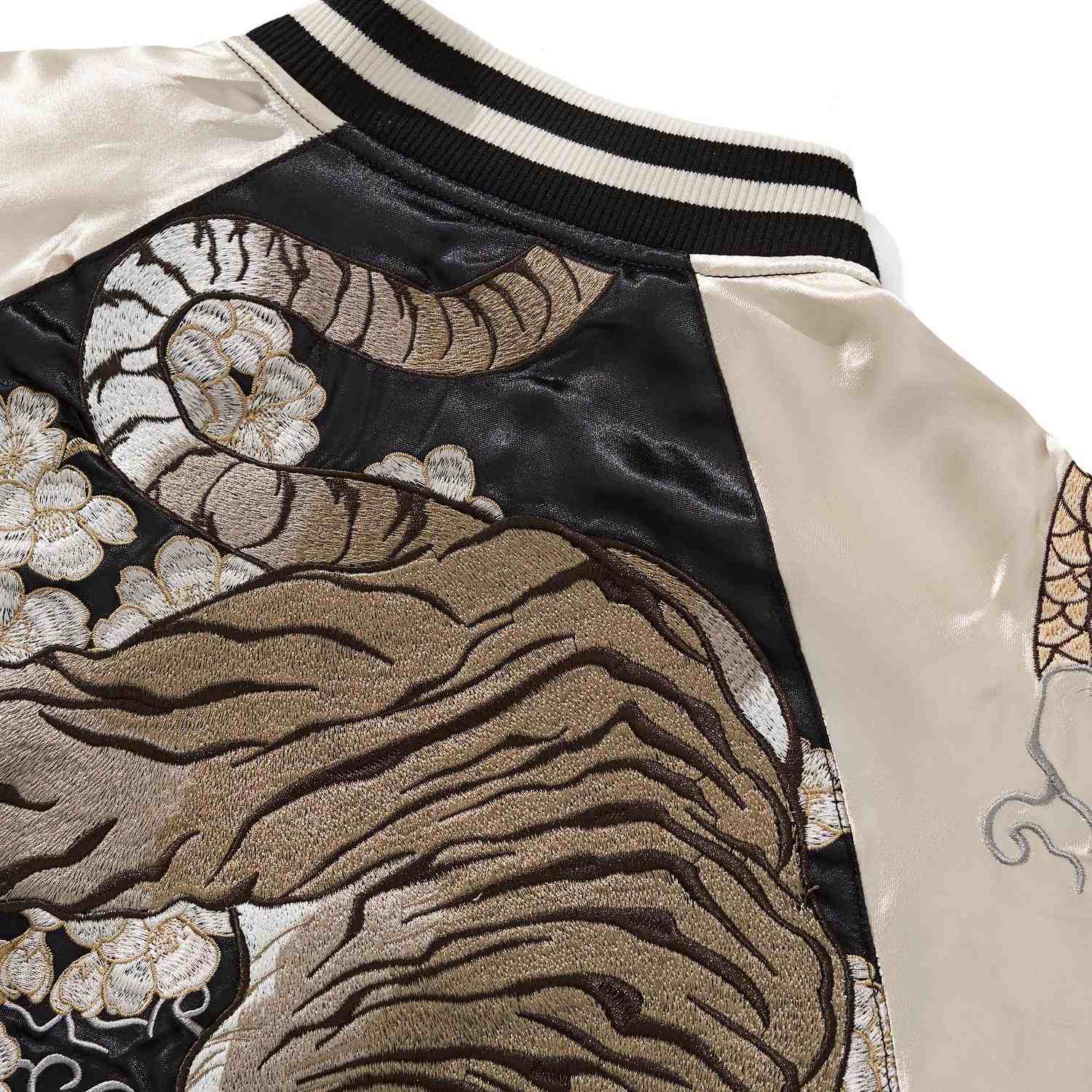 Shoulder detail—tiger tail sweeping across blossoms.