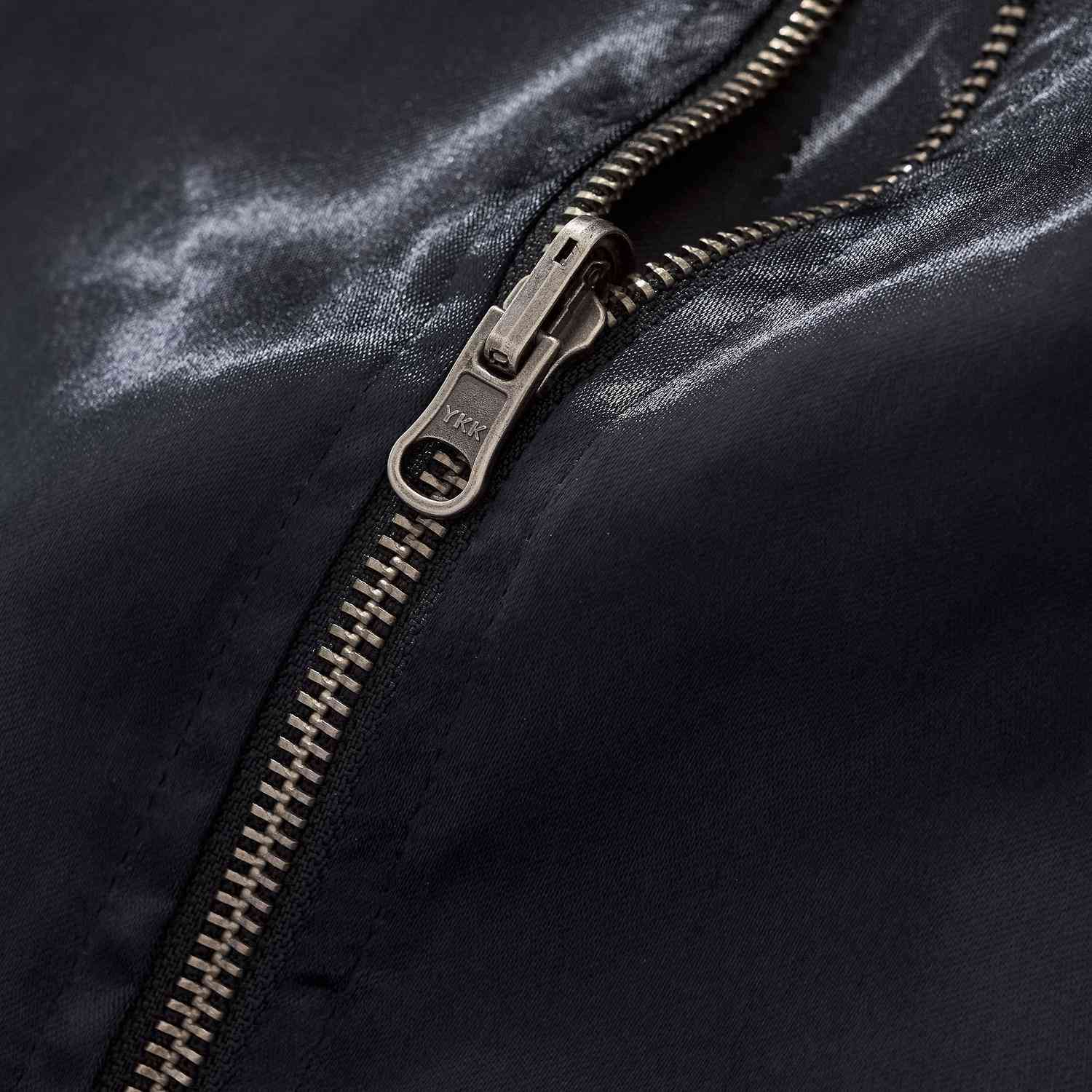 Close-up of sturdy YKK zipper on the navy body of Twin Dragons & Sakura embroidered sukajan jacket.