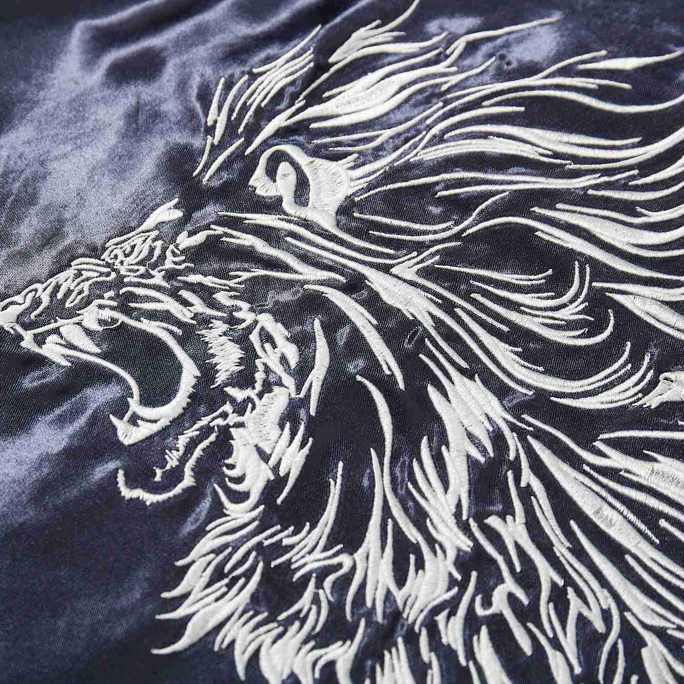 Embroidered roaring lion head outline with bold white threads.