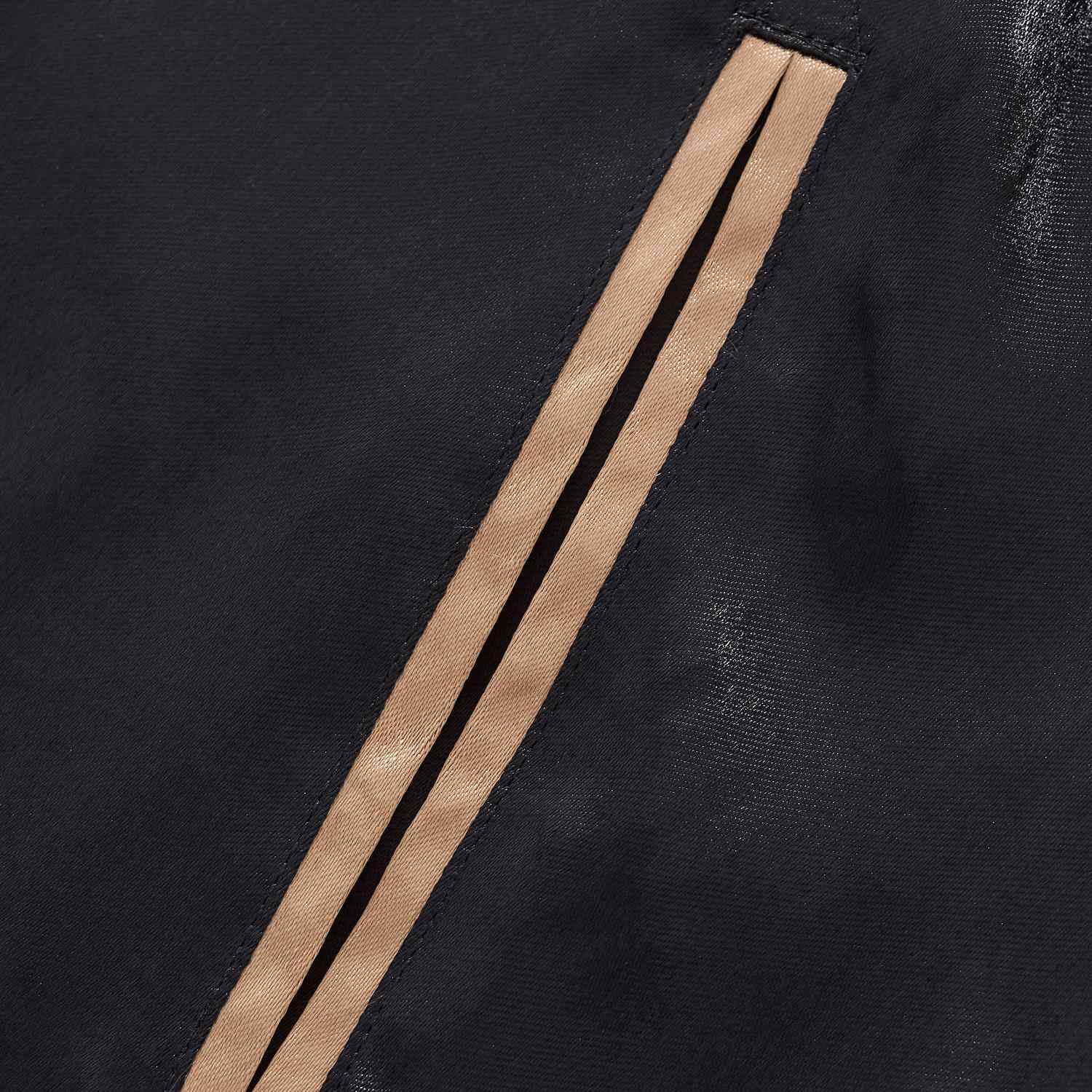 Gold welt pocket trim detail on black body.