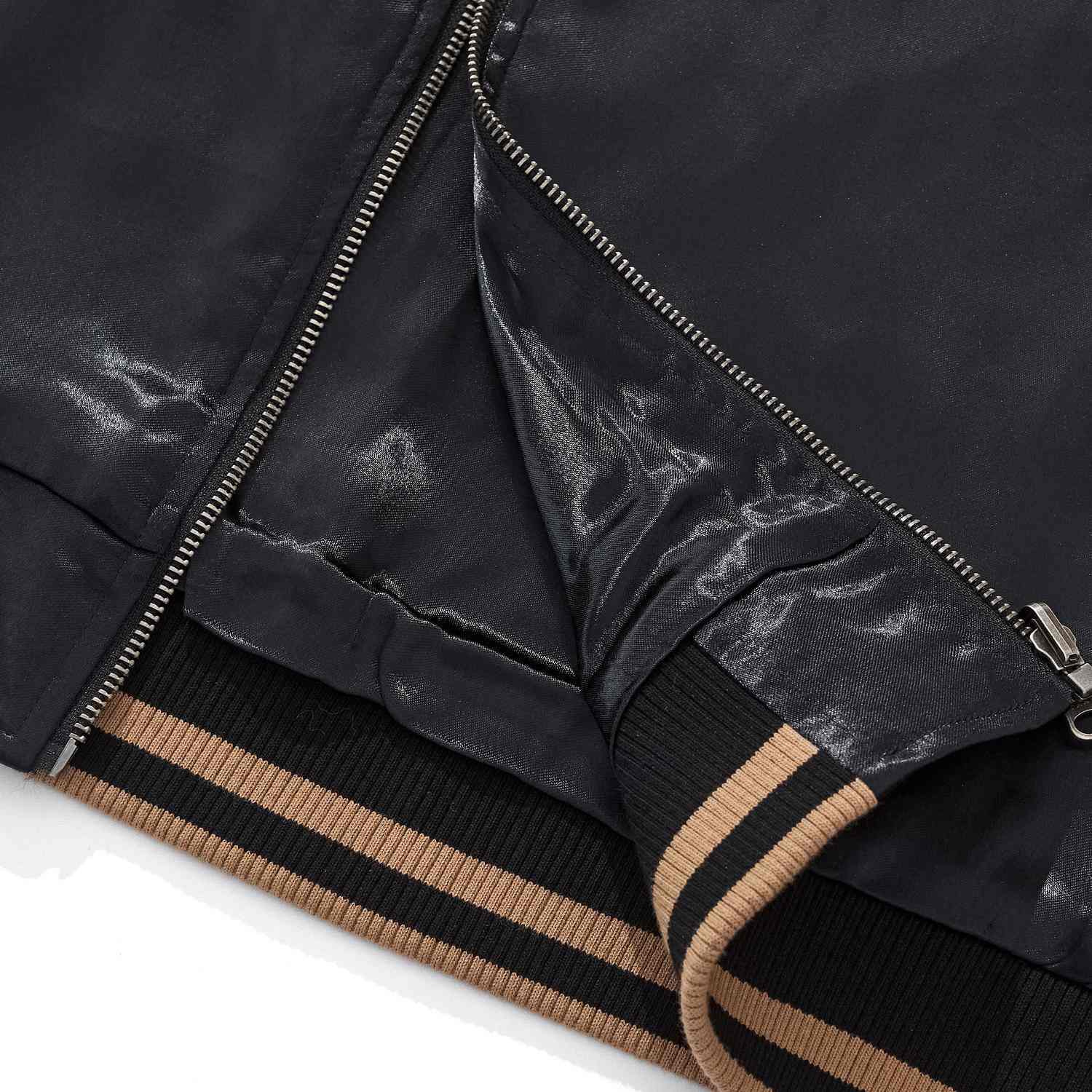 Hem detail — rib knit cuff and YKK zipper placket.