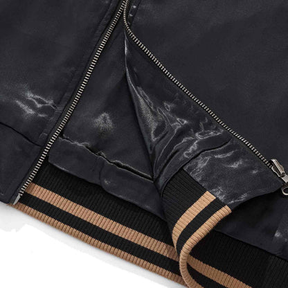 Hem detail — rib knit cuff and YKK zipper placket.