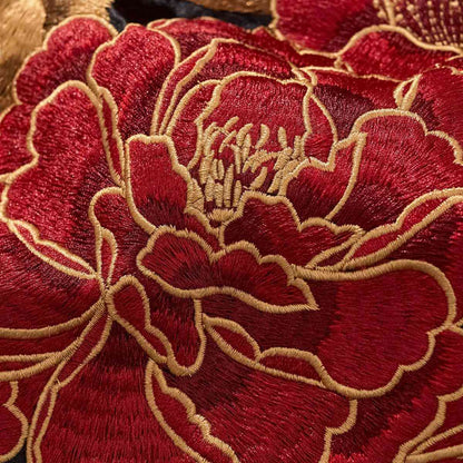 Macro embroidery — layered peony petals with golden outlines.