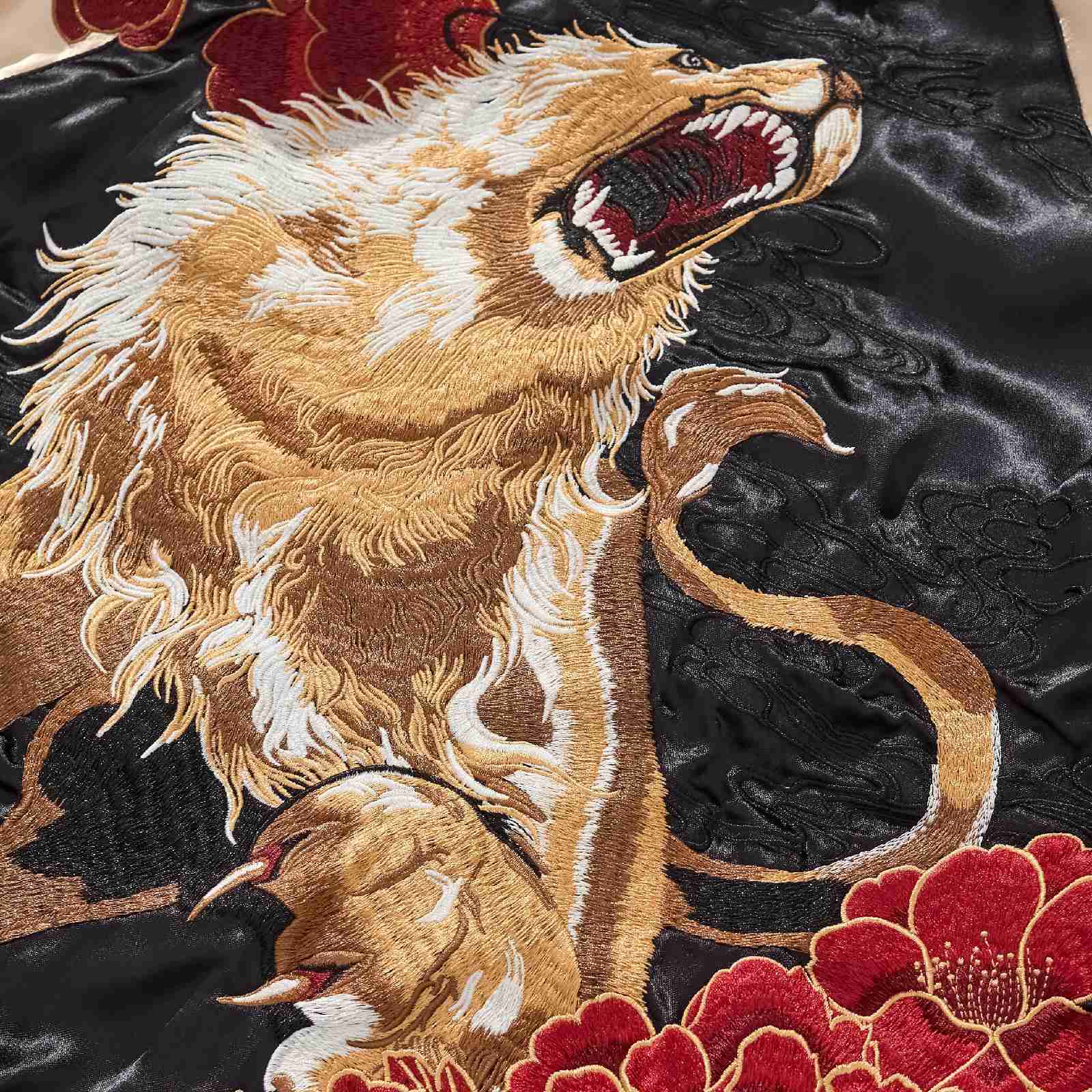 Back detail — roaring lion mane with red peonies, layered embroidery.