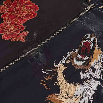 Front detail — YKK zipper framed by lion head and peony motifs.