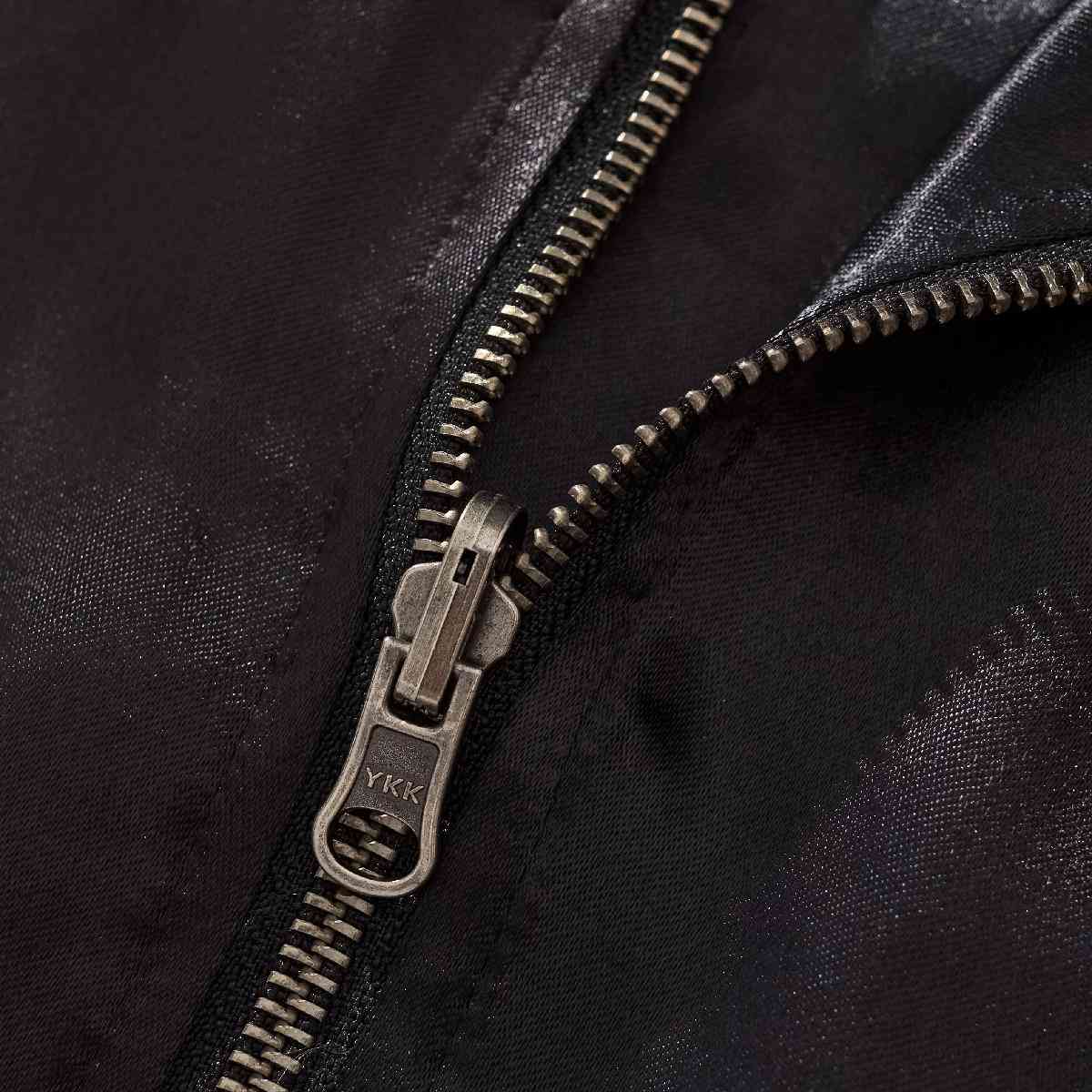 Hardware close-up — YKK metal zipper teeth and slider.
