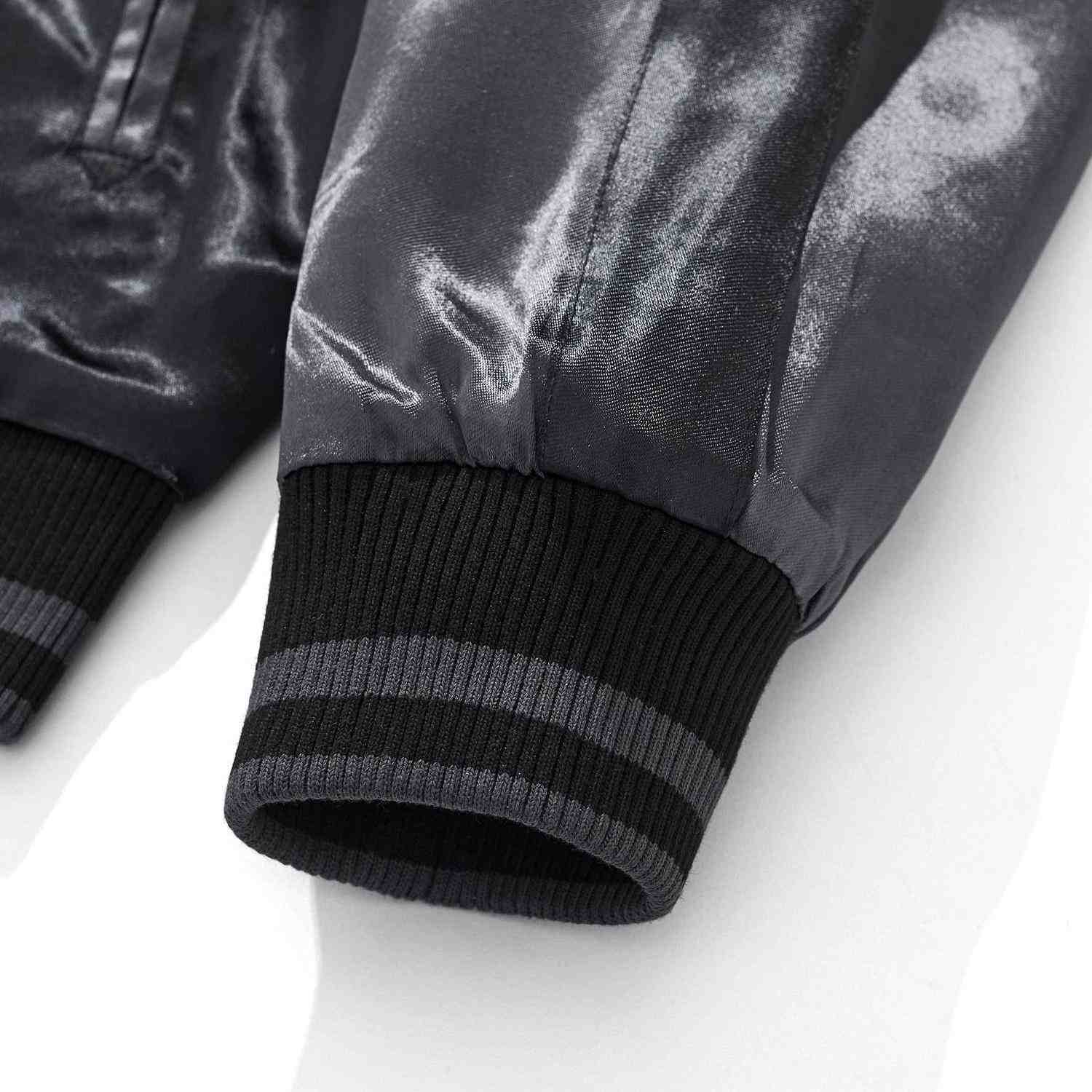 Ribbed cuff detail with contrast stripes.